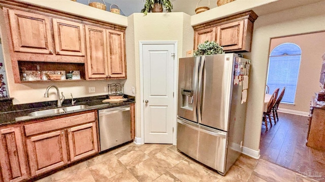 6214 Plum Orchard Way, Crestview, FL 32536 - kitchen with appliances with stainless steel finishes, a sink, baseboards, and dark stone countertops