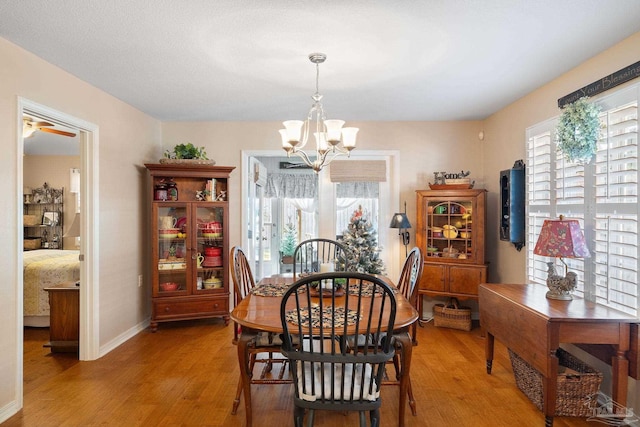 dining space featuring light hardwood / wood-style floors and an inviting chandelier