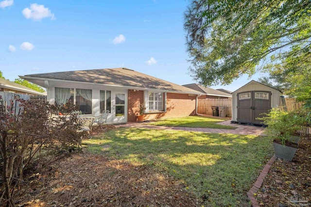 rear view of property featuring a shed and a yard