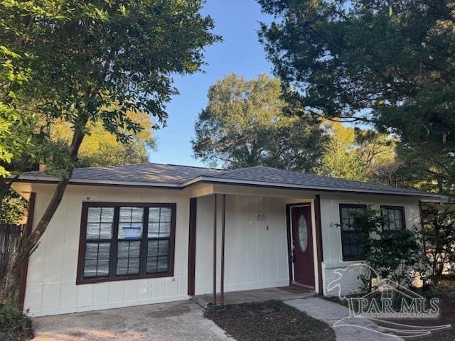 single story home with roof with shingles