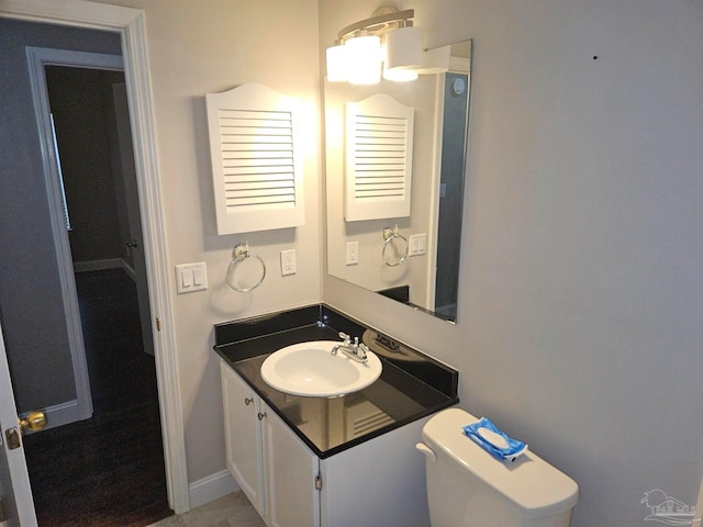 2201 Scenic Hwy Unit E-7, Pensacola, FL 32503 - half bathroom featuring toilet, vanity, and baseboards