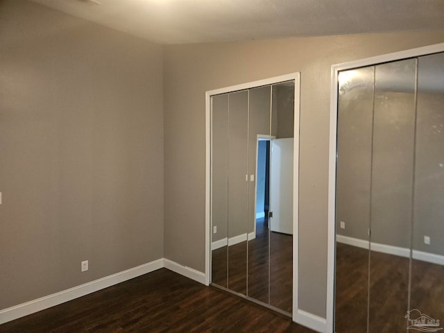 2201 Scenic Hwy Unit E-7, Pensacola, FL 32503 - unfurnished bedroom with dark wood finished floors and baseboards