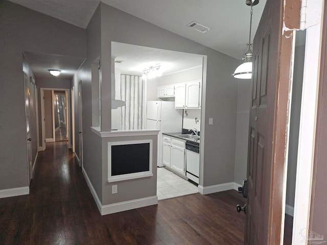 2201 Scenic Hwy Unit E-7, Pensacola, FL 32503 - kitchen with white appliances, a sink, wood finished floors, white cabinets, and lofted ceiling
