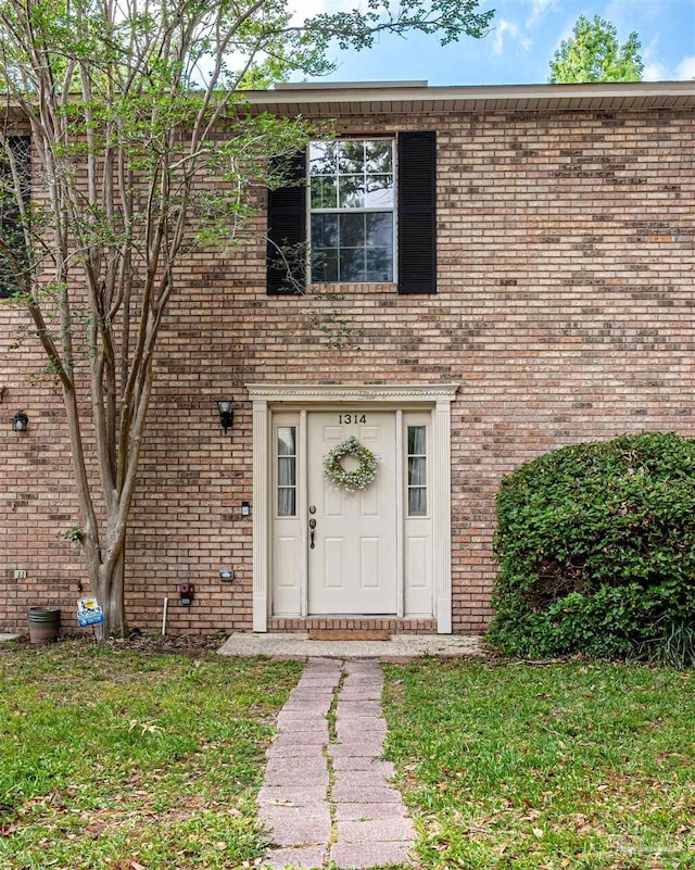 1314 Foxborough Dr, Pensacola, FL 32514 - doorway to property featuring brick siding and a yard