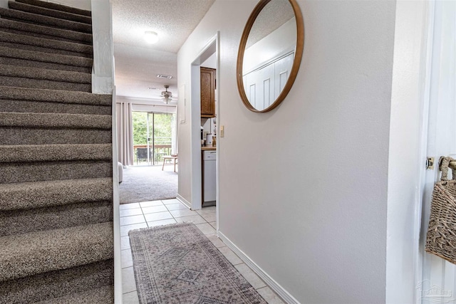 1314 Foxborough Dr, Pensacola, FL 32514 - hallway featuring light tile patterned flooring, stairway, a textured ceiling, and baseboards