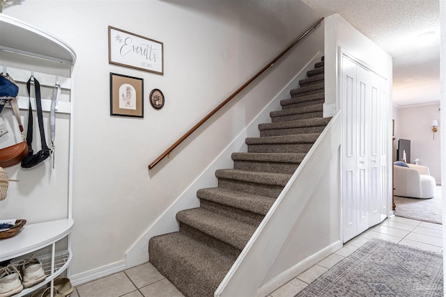 1314 Foxborough Dr, Pensacola, FL 32514 - staircase with baseboards, tile patterned floors, and a textured ceiling