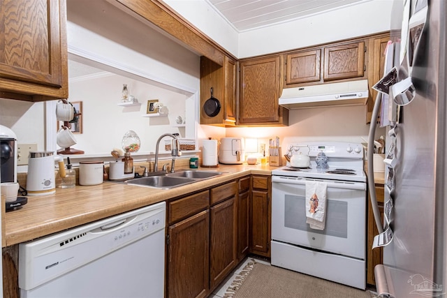 1314 Foxborough Dr, Pensacola, FL 32514 - kitchen featuring a sink, white appliances, brown cabinets, light countertops, and under cabinet range hood