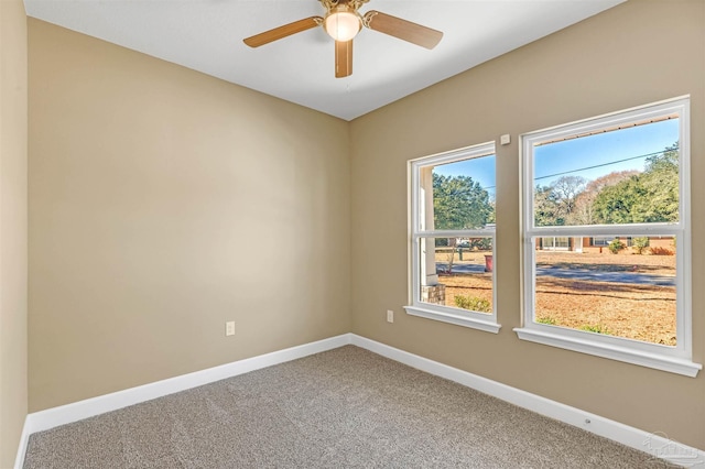 spare room featuring ceiling fan and carpet