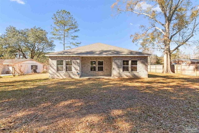 back of house featuring a lawn