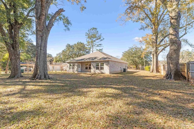 back of property featuring a lawn