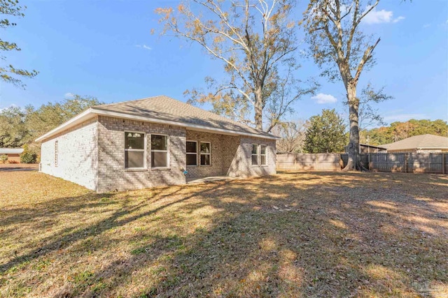 back of house with a lawn