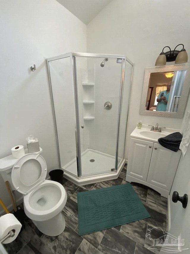 bathroom with toilet, lofted ceiling, a shower with shower door, and vanity