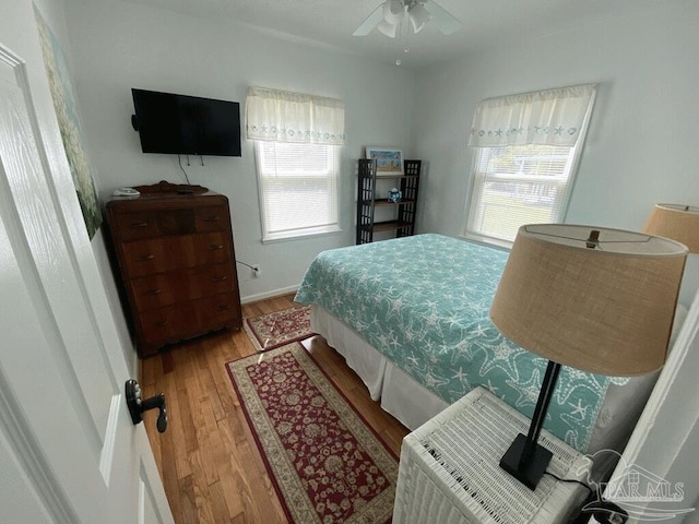 bedroom with hardwood / wood-style flooring and ceiling fan