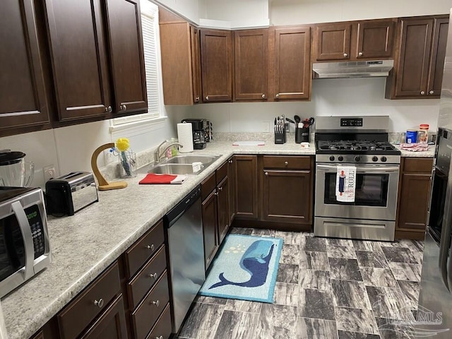 kitchen with sink, appliances with stainless steel finishes, and dark brown cabinets