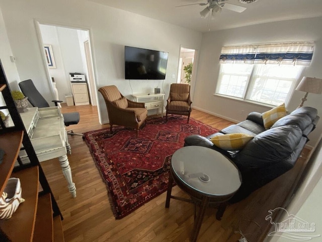 living room with hardwood / wood-style floors and ceiling fan