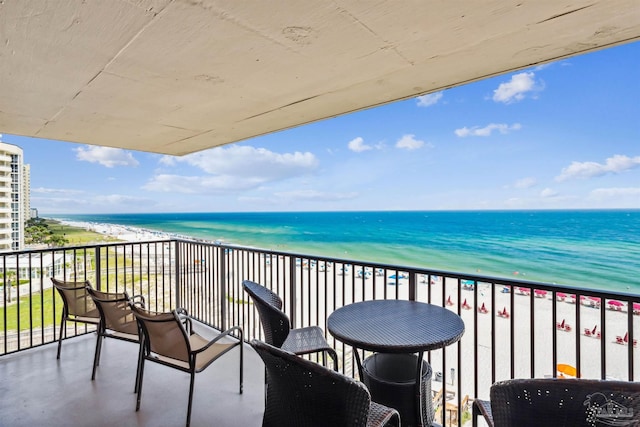 balcony featuring a beach view and a water view