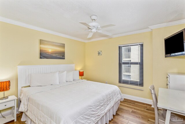 bedroom with ceiling fan, crown molding, and light hardwood / wood-style flooring