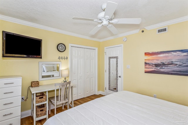 bedroom featuring ceiling fan, ornamental molding, and wood-type flooring