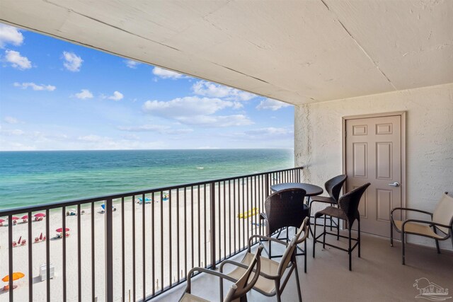 balcony featuring a water view and a view of the beach