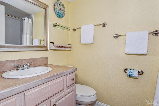 bathroom featuring toilet and vanity