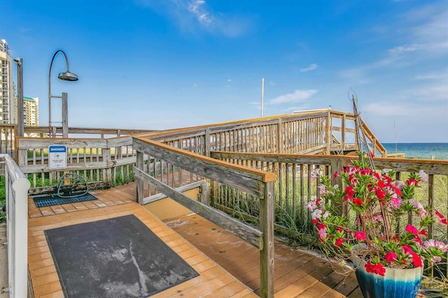 wooden terrace featuring a water view