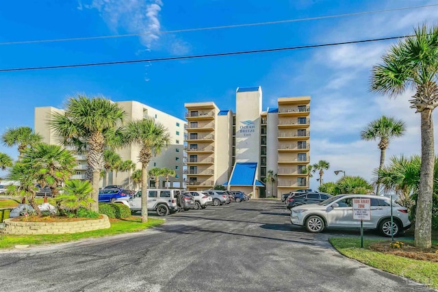 view of building exterior featuring uncovered parking