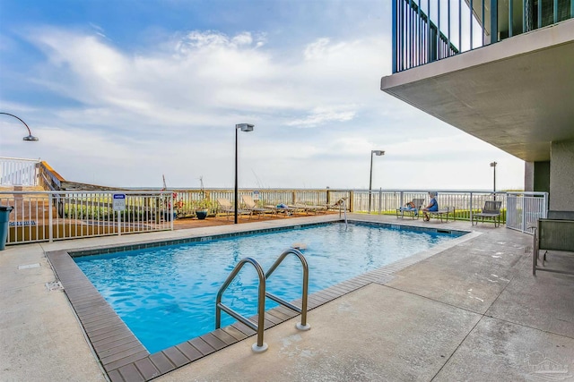 view of swimming pool with a patio area