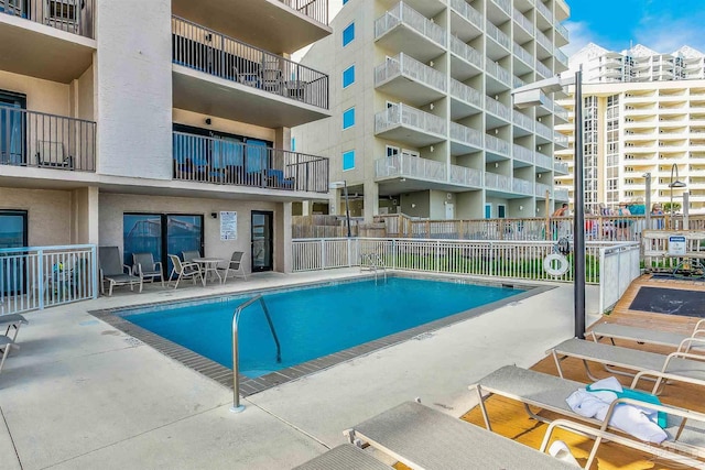 view of swimming pool featuring a patio area