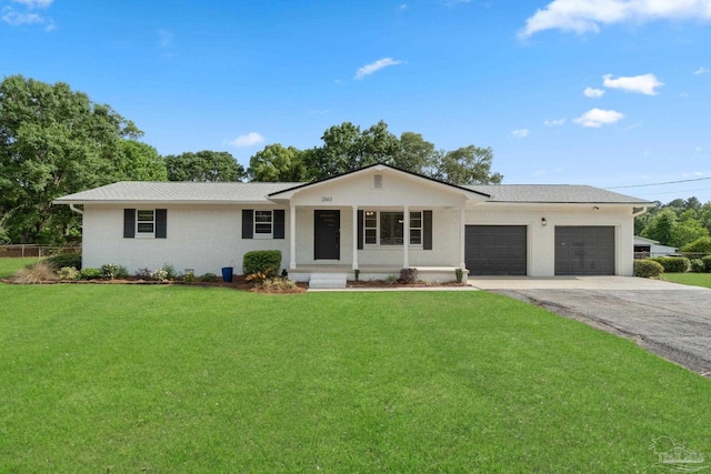 2663 E Kingsfield Rd, Pensacola, FL 32534 - ranch-style home featuring a garage, driveway, a front yard, and covered porch