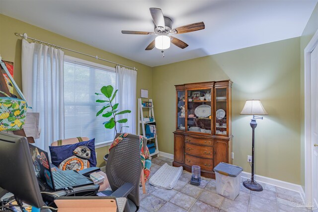 office featuring ceiling fan and baseboards