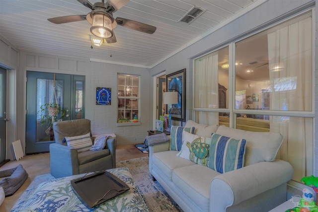living area with visible vents and ceiling fan