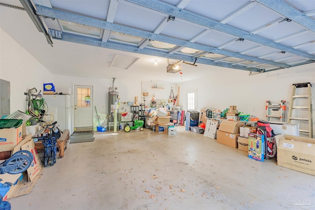 garage featuring a garage door opener, electric panel, and water heater