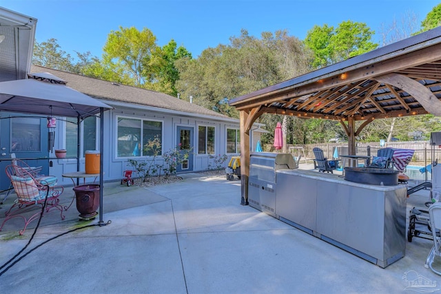 view of patio / terrace featuring a gazebo, a fire pit, grilling area, and fence