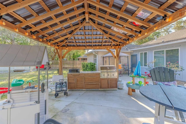 view of patio featuring a gazebo, a grill, and fence