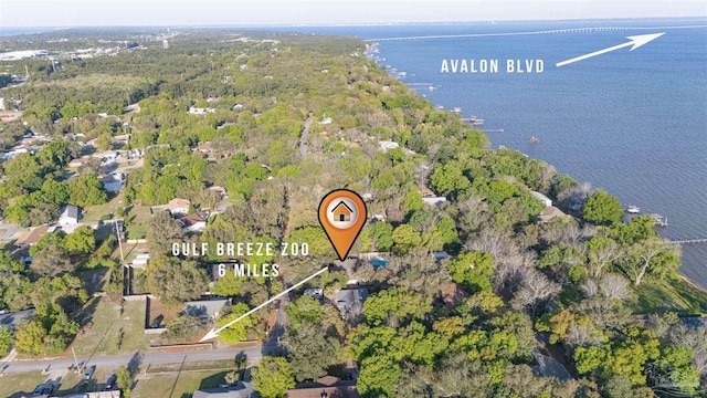 aerial view with a wooded view and a water view