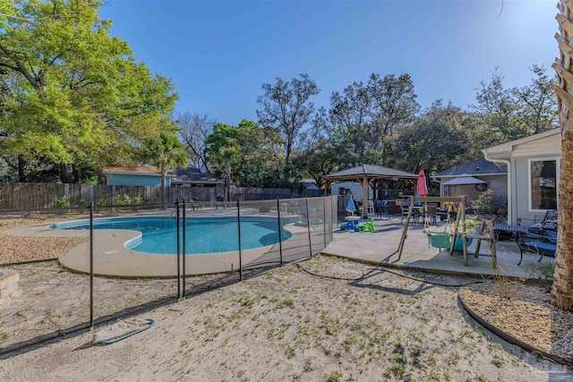 view of pool with a fenced in pool, a gazebo, a patio area, and a fenced backyard
