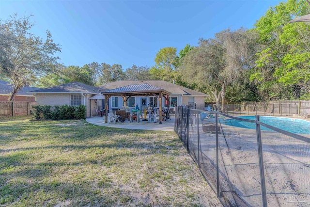exterior space with a fenced in pool, a yard, a patio area, a gazebo, and fence
