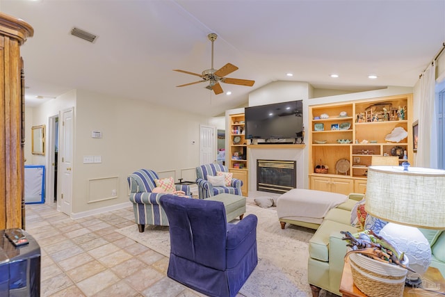 living area with visible vents, ceiling fan, recessed lighting, a glass covered fireplace, and lofted ceiling