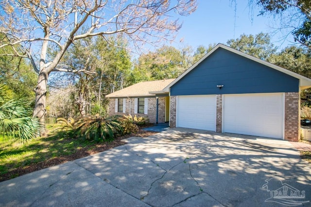 ranch-style house with driveway, an attached garage, and brick siding