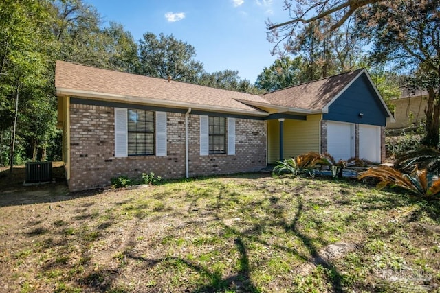 ranch-style house featuring a garage, a shingled roof, central AC unit, and brick siding