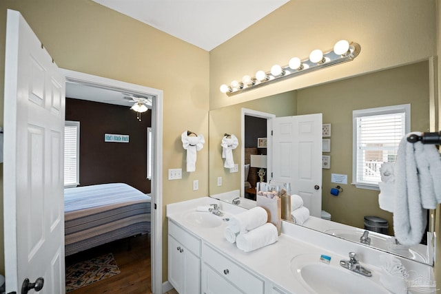 446 Harbor Light Cir, Gulf Shores, AL 36542 - ensuite bathroom with toilet, double vanity, wood finished floors, and ceiling fan