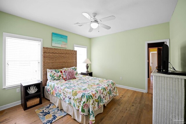 446 Harbor Light Cir, Gulf Shores, AL 36542 - bedroom with baseboards, hardwood / wood-style flooring, and ceiling fan