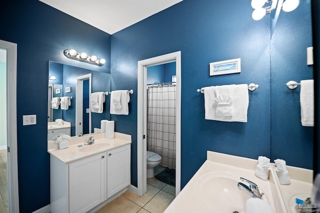446 Harbor Light Cir, Gulf Shores, AL 36542 - full bath featuring tile patterned floors, two vanities, baseboards, and toilet