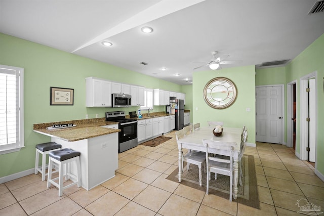 446 Harbor Light Cir, Gulf Shores, AL 36542 - kitchen with appliances with stainless steel finishes, a sink, white cabinets, plenty of natural light, and recessed lighting