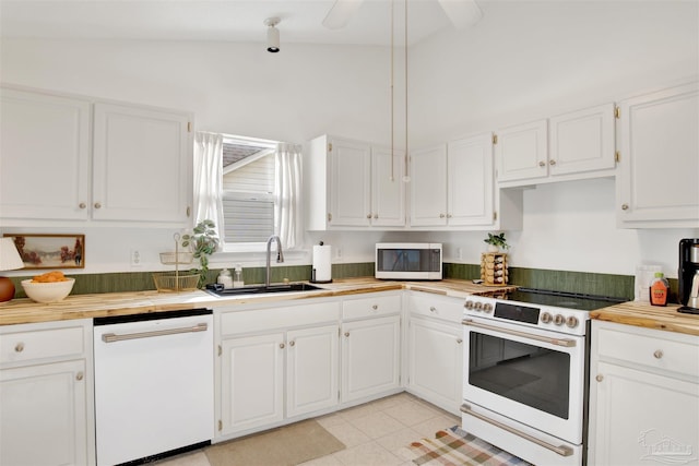 kitchen with white cabinets, lofted ceiling, and white appliances