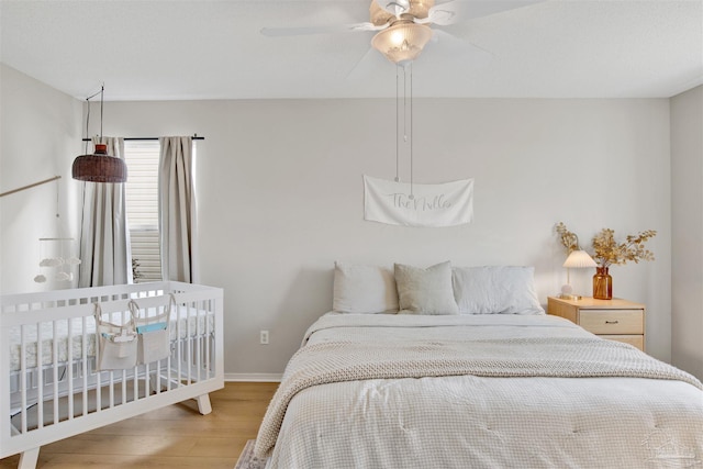 bedroom featuring light hardwood / wood-style floors and ceiling fan