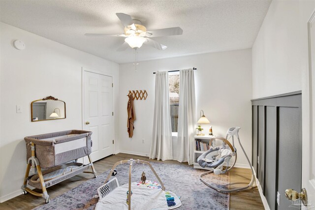 interior space featuring ceiling fan, a textured ceiling, and hardwood / wood-style flooring