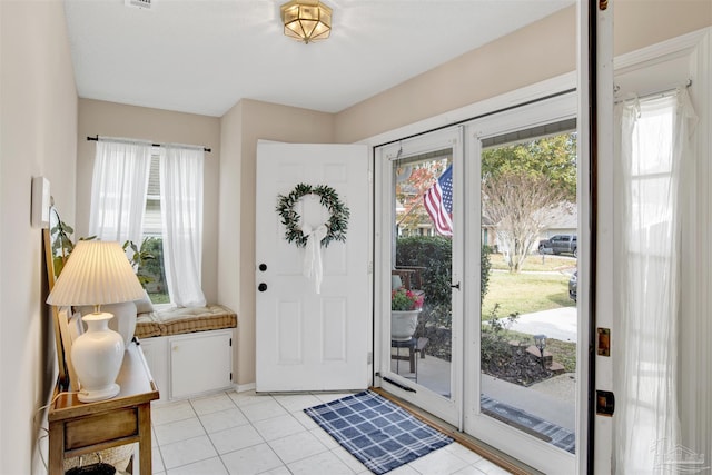 foyer entrance with light tile patterned floors