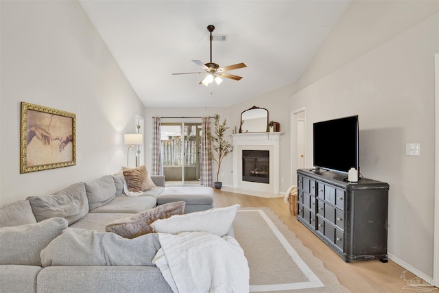 living room with ceiling fan and lofted ceiling