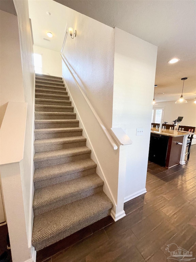 stairs with hardwood / wood-style floors